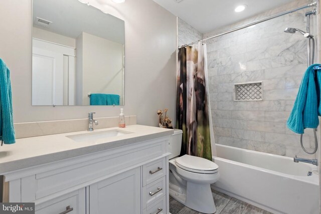  - bathroom with vanity, shower / tub combo with curtain, and wood finished floors