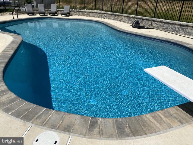  - view of pool featuring a diving board