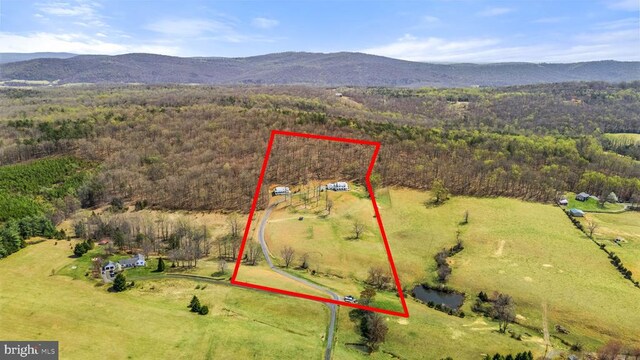  - view of rural area with property boundaries highlighted and a mountain backdrop