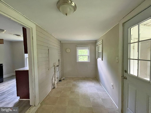 clothes washing area featuring wooden walls