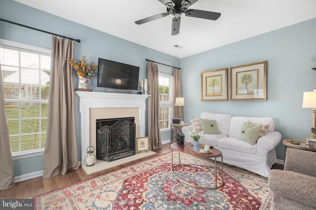9301 Glascow Dr, Fredericksburg, VA 22408 - living area featuring wood finished floors, ceiling fan, a fireplace, and baseboards