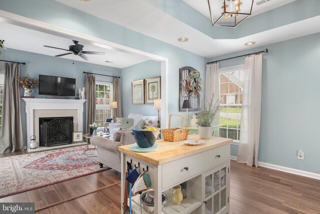 9301 Glascow Dr, Fredericksburg, VA 22408 - living room with wood finished floors, plenty of natural light, baseboards, a fireplace with raised hearth, and recessed lighting