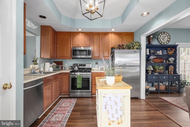 9301 Glascow Dr, Fredericksburg, VA 22408 - kitchen featuring stainless steel appliances, a chandelier, a sink, brown cabinetry, and recessed lighting