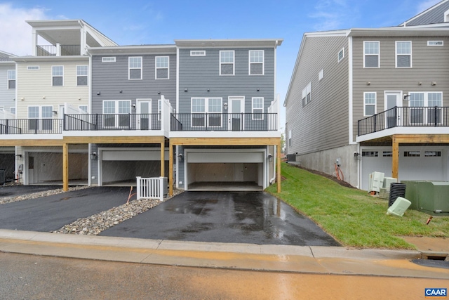 27 Woodburn Rd, Charlottesville, VA 22901 - rear view of house featuring an attached garage, driveway, and a lawn