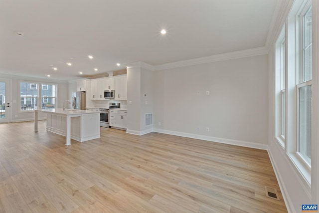 27 Woodburn Rd, Charlottesville, VA 22901 - unfurnished living room featuring ornamental molding, light wood-style flooring, and recessed lighting