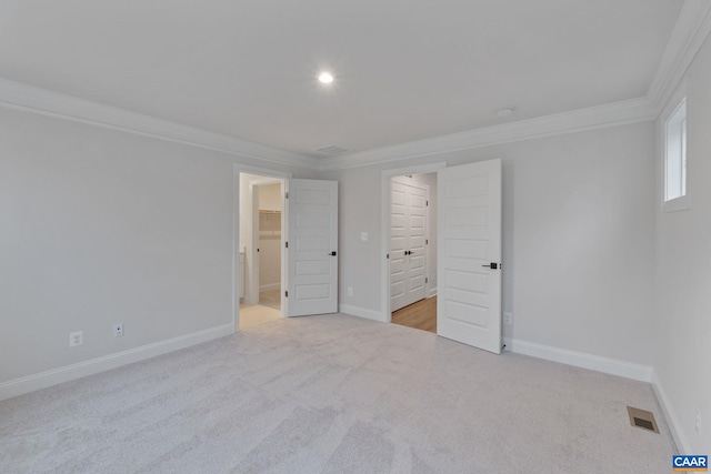 27 Woodburn Rd, Charlottesville, VA 22901 - unfurnished bedroom featuring ornamental molding, light carpet, and a walk in closet