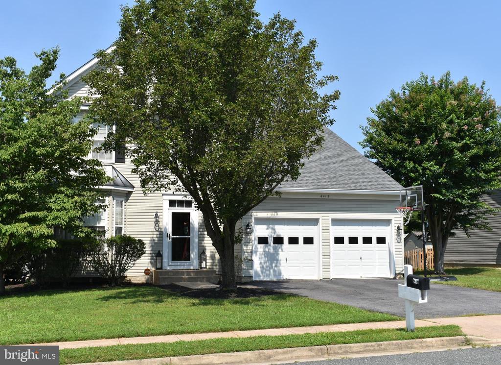 6415 Hot Spring Ln, Fredericksburg, VA 22407 - obstructed view of property with driveway, a garage, a front lawn, and a shingled roof
