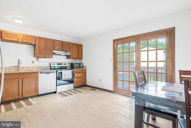 5129 Pecan Dr, Fredericksburg, VA 22407 - kitchen with appliances with stainless steel finishes, under cabinet range hood, a sink, light wood-style flooring, and brown cabinetry