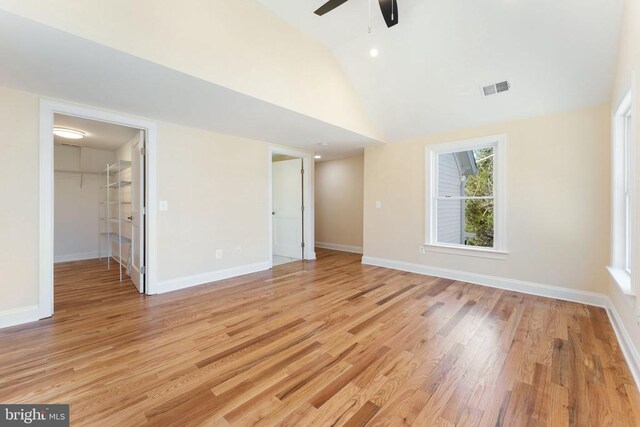 spare room featuring ceiling fan, high vaulted ceiling, and light wood-type flooring