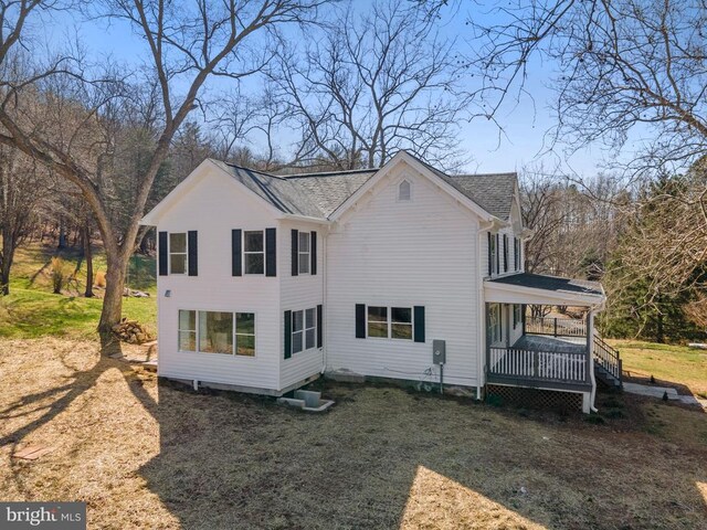 exterior space featuring a porch and a yard