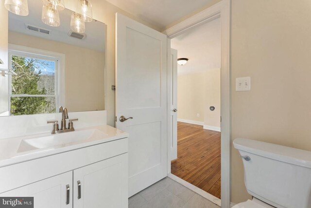 bathroom with vanity, toilet, and tile patterned flooring