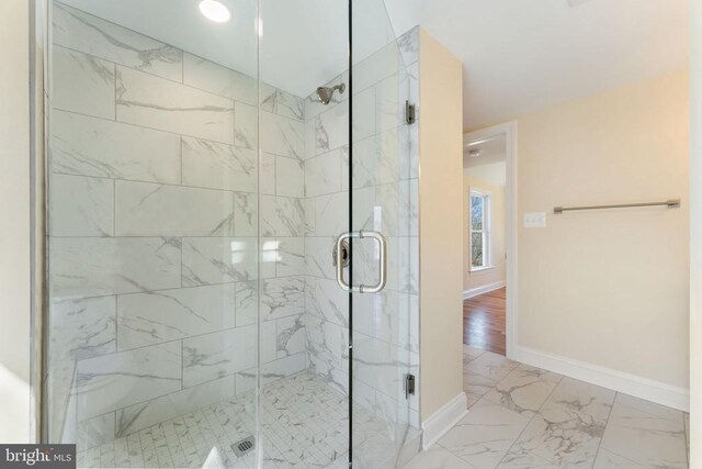 bathroom featuring a shower with shower door