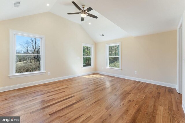 empty room featuring vaulted ceiling, ceiling fan, and light wood-type flooring