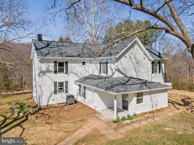 rear view of house featuring central AC unit and a patio area