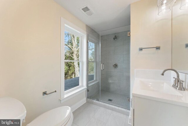 bathroom featuring vanity, toilet, and an enclosed shower