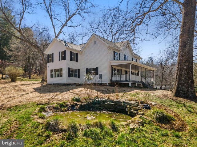 rear view of property with a porch