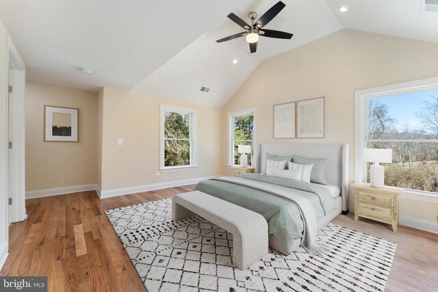 bedroom with lofted ceiling, ceiling fan, and light hardwood / wood-style flooring