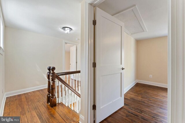 hallway with dark hardwood / wood-style flooring