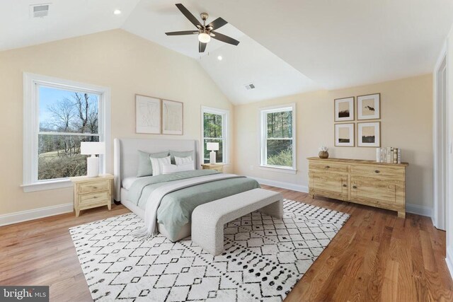 bedroom featuring light hardwood / wood-style flooring, vaulted ceiling, and ceiling fan