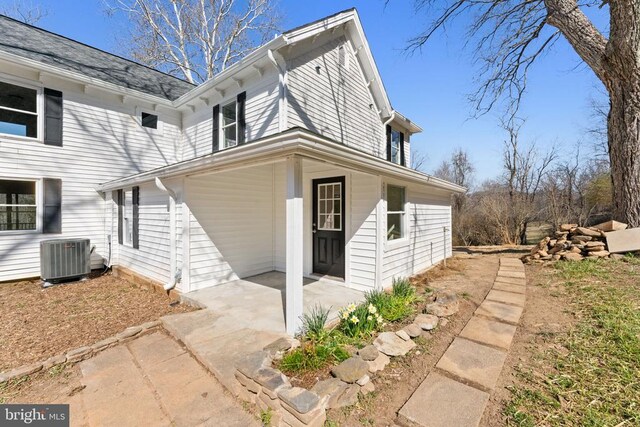 exterior space with a patio and cooling unit