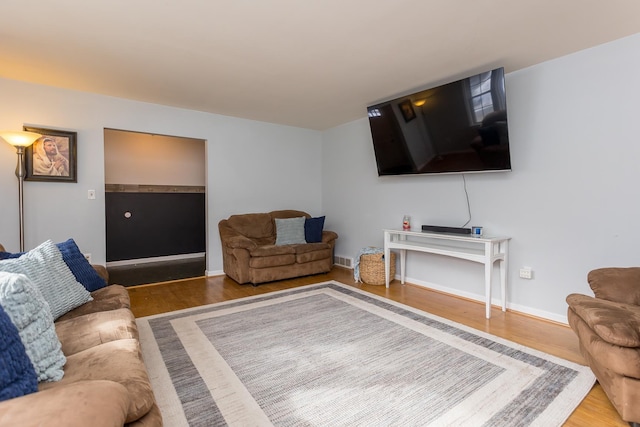 living room featuring baseboards and wood finished floors