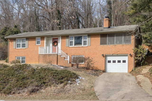 single story home featuring concrete driveway, brick siding, a chimney, and a garage