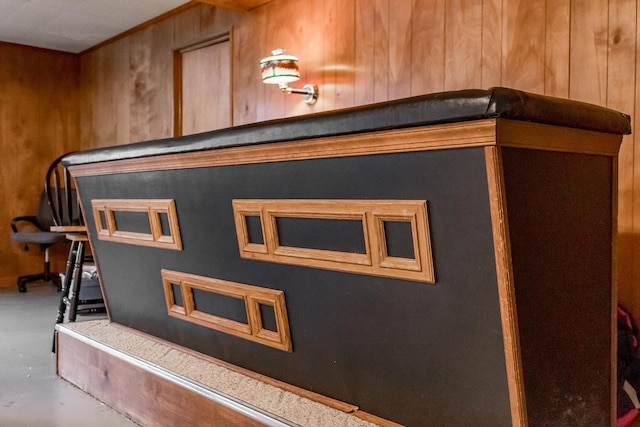 interior details with wood walls and concrete flooring