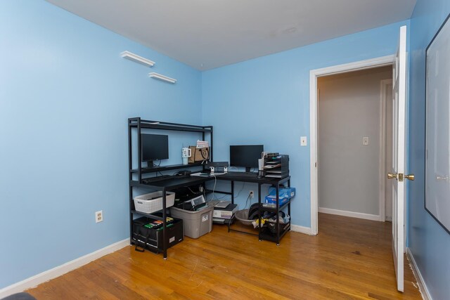 office area featuring baseboards and wood finished floors