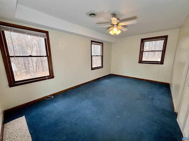 3264 Martin Kings Rd, Charlottesville, VA 22903 - empty room with baseboards, dark carpet, a ceiling fan, and a wealth of natural light