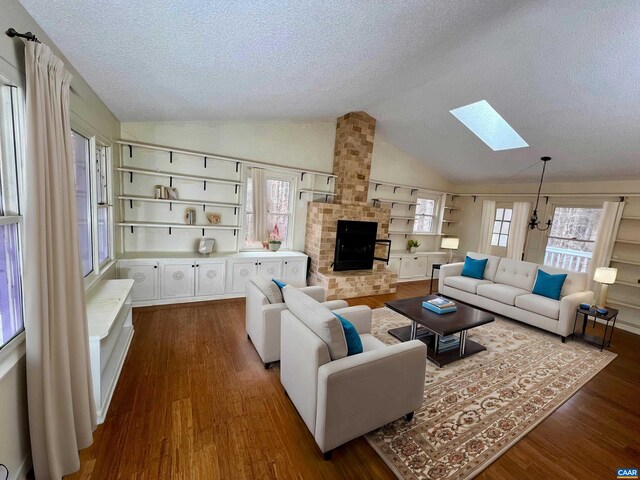 3264 Martin Kings Rd, Charlottesville, VA 22903 - living room with a fireplace, a textured ceiling, lofted ceiling with skylight, and dark wood-style floors