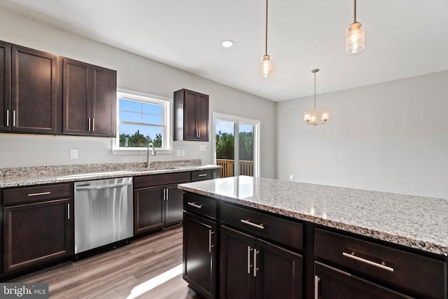 Kentuck Pl, Mineral, VA 23117 - kitchen with stainless steel dishwasher, a sink, light wood finished floors, hanging light fixtures, and dark brown cabinetry