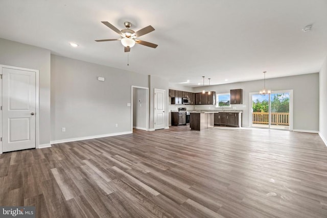 Kentuck Pl, Mineral, VA 23117 - unfurnished living room with wood finished floors, ceiling fan, baseboards, a chandelier, and recessed lighting