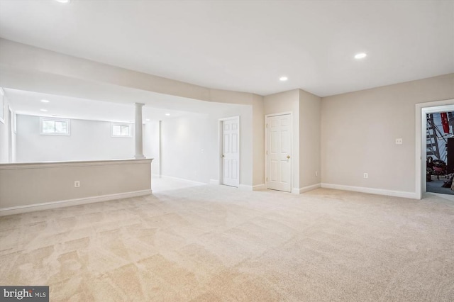 basement featuring light colored carpet, recessed lighting, and baseboards