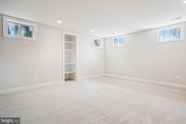 below grade area featuring light colored carpet, baseboards, and recessed lighting