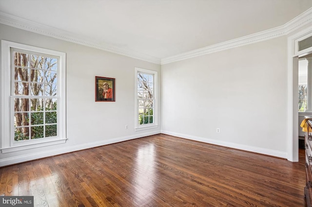 unfurnished room with dark wood-style floors, baseboards, and ornamental molding