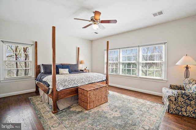 bedroom with baseboards, dark wood finished floors, and a ceiling fan