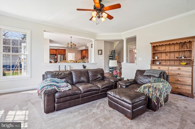 living area with decorative columns, carpet floors, a ceiling fan, ornamental molding, and a chandelier