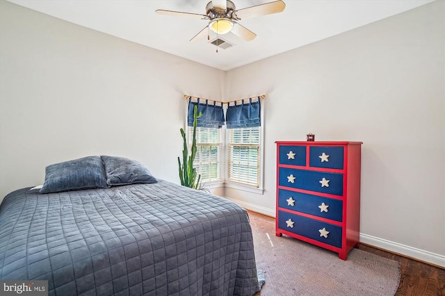 bedroom featuring baseboards, a ceiling fan, and wood finished floors