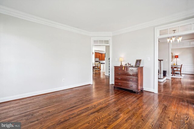 bedroom with dark wood-style flooring, crown molding, and baseboards