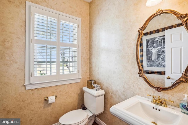 half bathroom with a sink and toilet