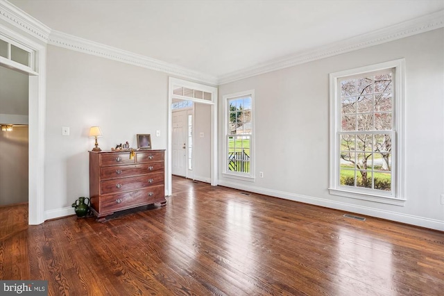 bedroom with wood finished floors, ornamental molding, and baseboards