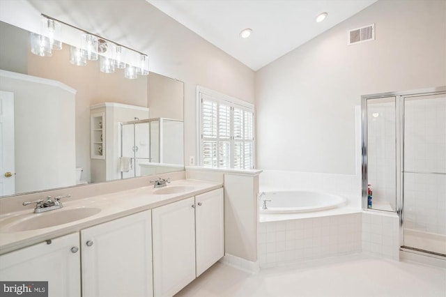 full bath with a bath, a stall shower, lofted ceiling, and double vanity