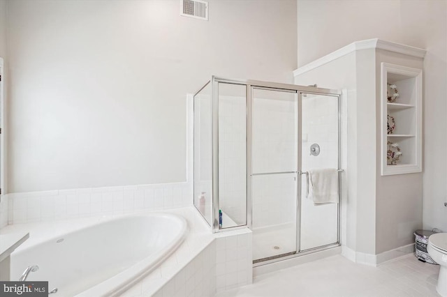 bathroom featuring a stall shower, a garden tub, and tile patterned flooring
