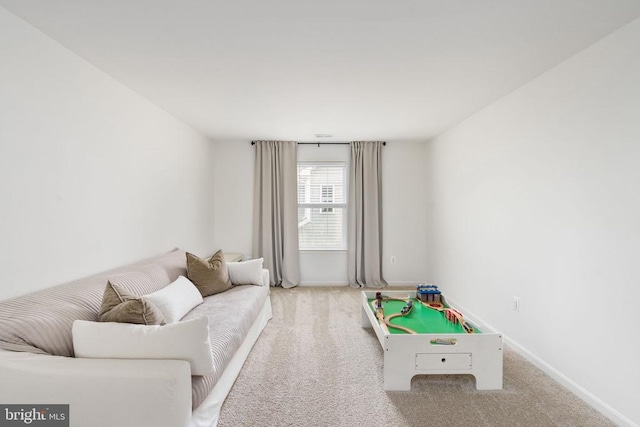 rec room featuring carpet and baseboards