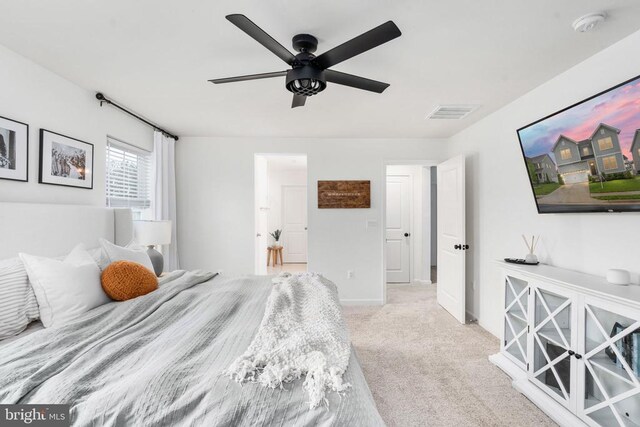 carpeted bedroom featuring a ceiling fan and baseboards