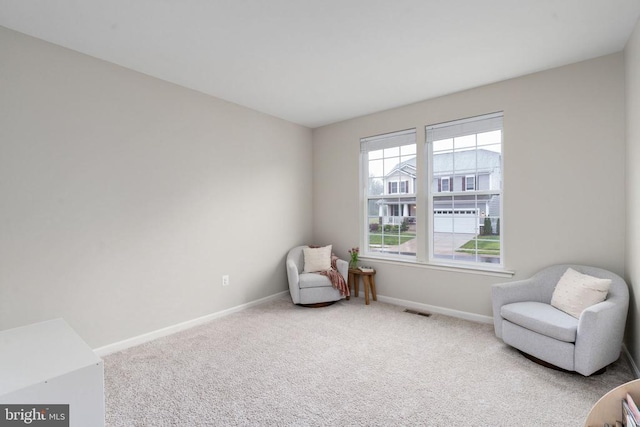 sitting room with carpet and baseboards