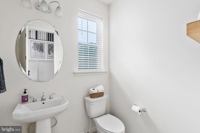 bathroom with toilet and a sink
