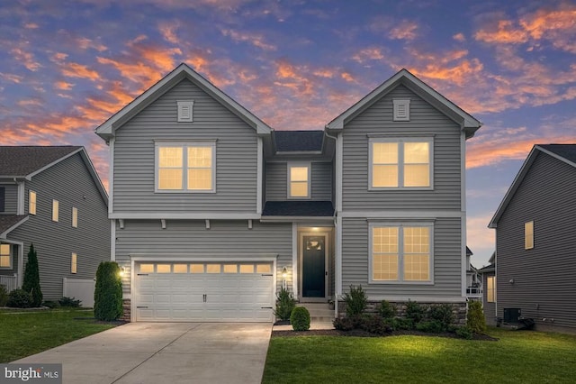 traditional-style home with a yard, concrete driveway, a garage, and cooling unit