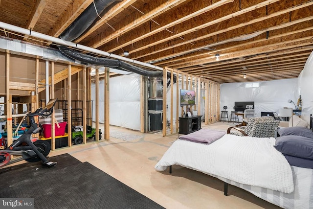 bedroom with concrete floors and a desk