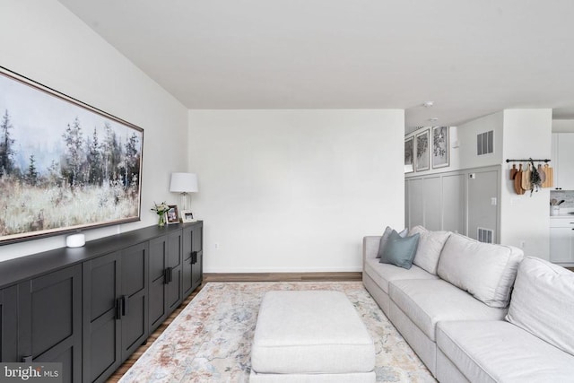 living room with wood finished floors and baseboards